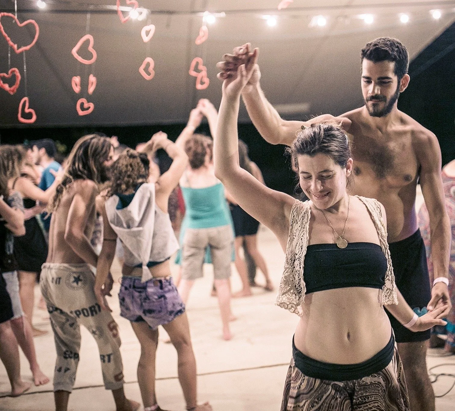 People dancing and connecting at a shared gathering